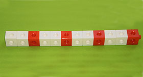 A line of twelve cubes made of four white-white-red groups.